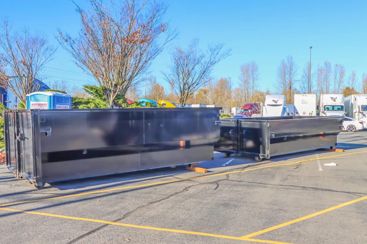 Professional dumpster rental service with roll-off container on residential driveway in Bee Ridge